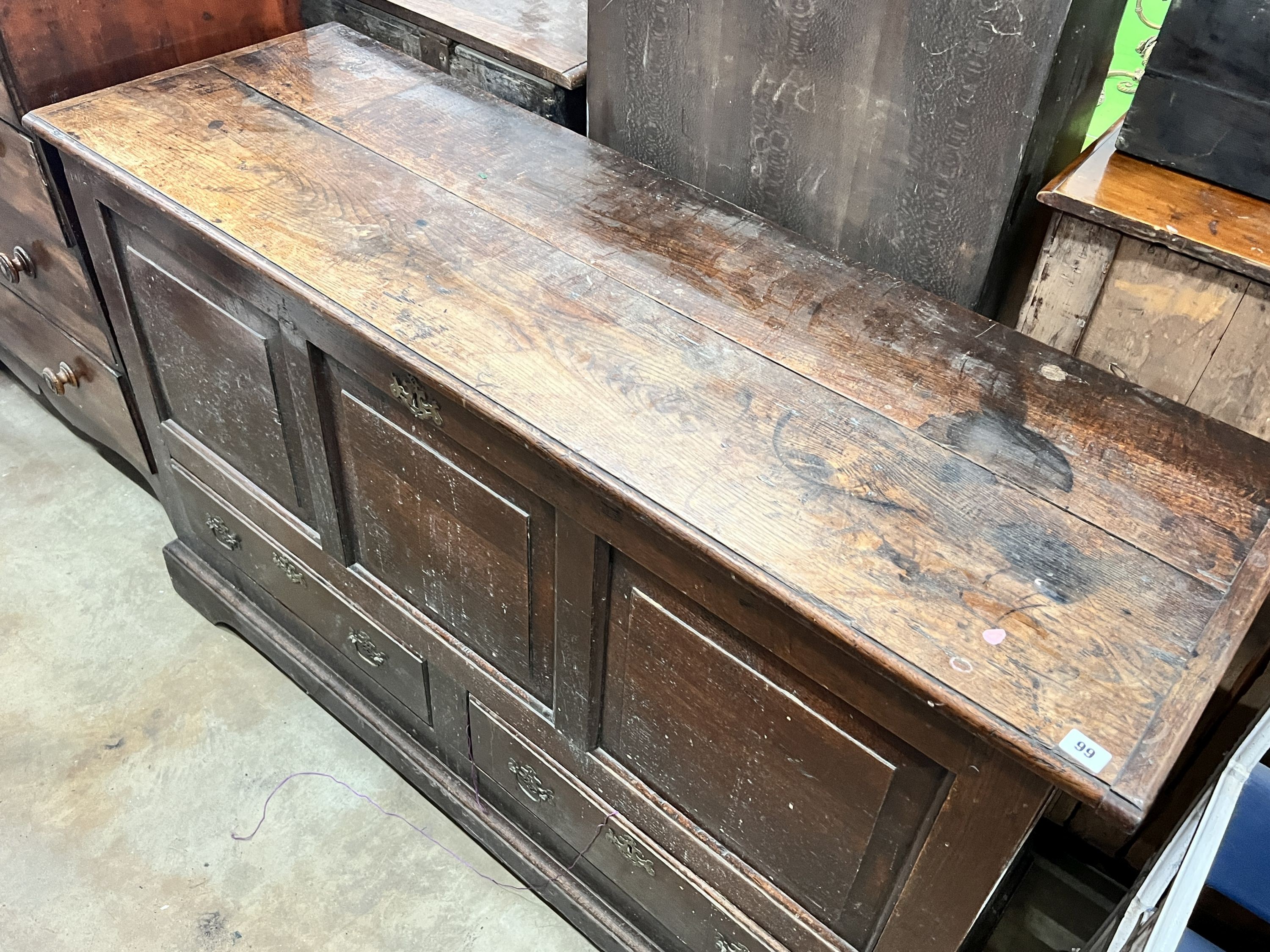 A mid 18th century oak mule chest with squared triple panelled front, width 151cm, depth 50cm, height 90cm